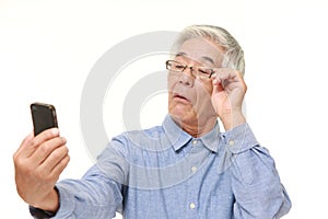 Senior Japanese man with presbyopia