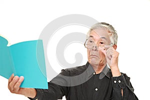 Senior Japanese man with presbyopia