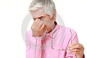Senior Japanese man suffers from Asthenopia photo