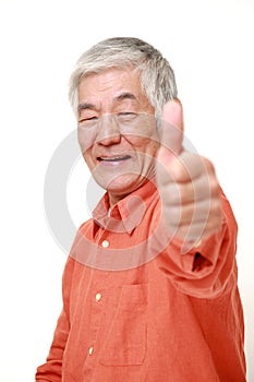 Senior Japanese man with thumbs up gesture