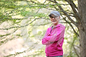 Senior Japanese man wearing pink parka smiles outdoor