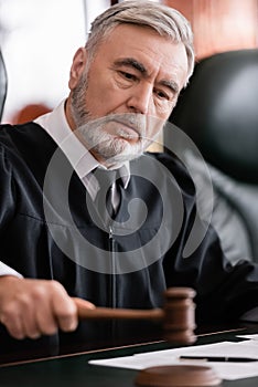 senior judge with blurred gavel sentencing