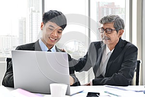 Senior and junior businessman discuss something during their meeting, Asian businessman, business concept