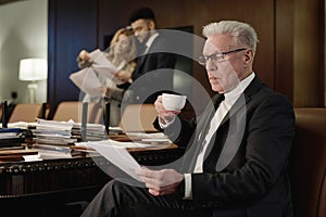 Senior Jurist Doing Paperwork in Office Conference Room