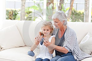 Senior knitting with her granddaughter