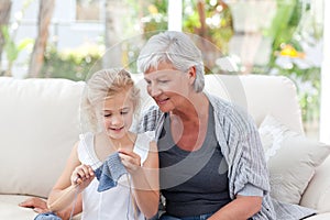 Senior knitting with her granddaughter