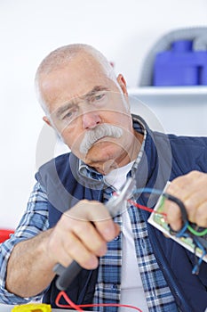 senior laborer in blue work wear