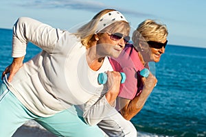 Senior ladies working out on beach. photo