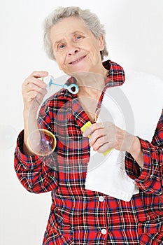 Senior lady blowing soap bubbles