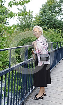 Senior lady on bridge photo
