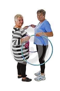 Senior lady doing gymnastic with hula hoop