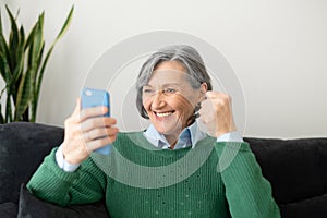 Senior lady excited to read good news online