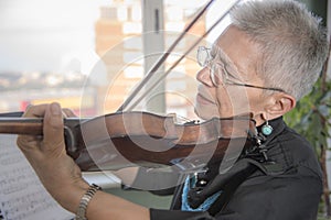 Senior lady playing violin