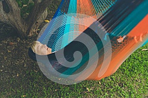 Senior lady relaxing in a hammock