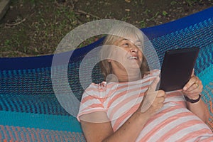 Senior lady relaxing in a hammock