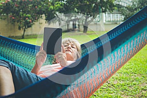 Senior lady relaxing in a hammock