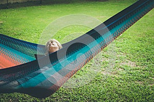 Senior lady relaxing in a hammock