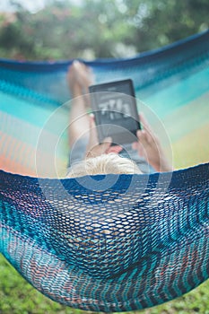 Senior lady relaxing in a hammock