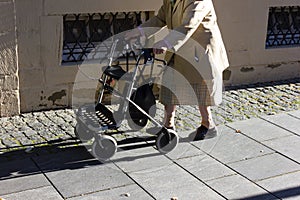 senior lady with rollator walking in a south german historical c