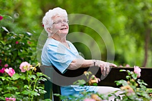 Senior lady in rose garden