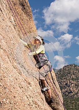 Senior lady on steep rock climb in Colorado