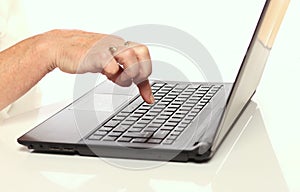 Mature woman hand over laptop keyboard. Woman hands typing on keyboard of laptop, online shopping detail. Business, remote.