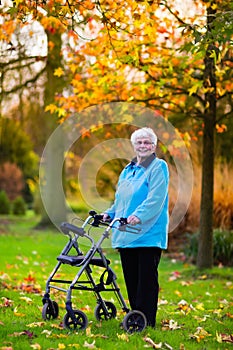 Senior lady with a walker in autumn park