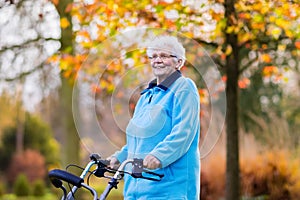 Senior lady with a walker in autumn park