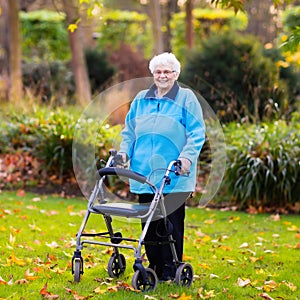 Senior lady with a walker in autumn park