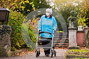 Senior lady with a walker in face mask