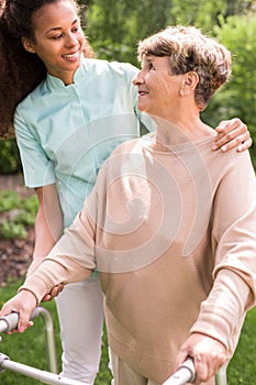 Senior lady with walking zimmer photo