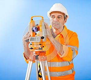 Senior land surveyor with theodolite