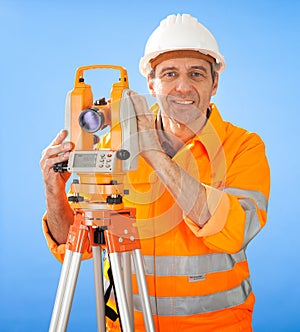 Senior land surveyor with theodolite