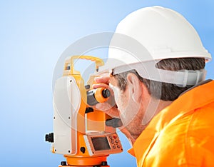 Senior land surveyor with theodolite