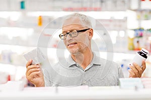 Senior male customer choosing drugs at pharmacy