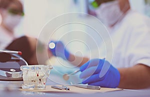 Senior male dentist adjust searchlight before starting work