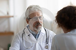 Senior male doctor consult patient at meeting