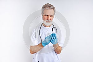 Senior male doctor is wearing sterile gloves, preparation
