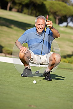 Senior Male Golfer On Golf Course