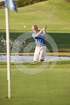 Senior Male Golfer Playing Bunker