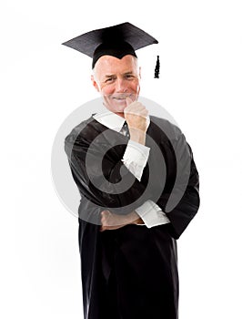 Senior male graduate standing with finger in mouth