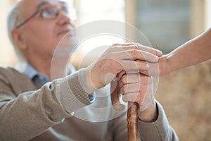 Senior male hands squeezing female hands