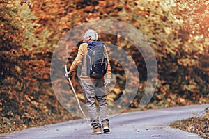 Senior male hiker walking with backpack