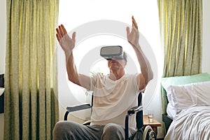 Senior male patient using virtual reality headset at retirement home