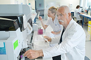 Senior male researcher carrying out scientific research in lab