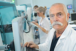 Senior male researcher carrying out scientific research in lab