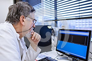 Senior male researcher carrying out scientific research in a lab