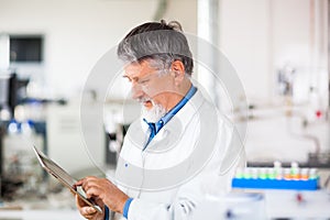 Senior male researcher carrying out scientific research in a lab