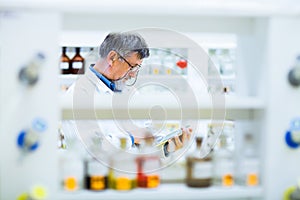 Senior male researcher carrying out scientific research in a lab