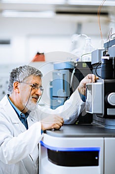 Senior male researcher carrying out scientific research in a lab